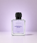 A 50 ml bottle of Rafiza Imperial Oud perfume with a clear glass body showing light purple liquid, a black textured cap, and silver lettering, set against a solid lavender background.