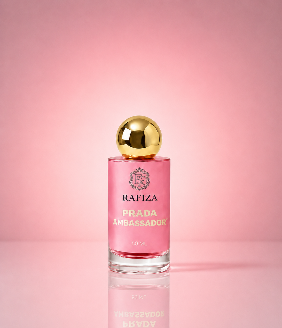 A 50ml bottle of Prada Ambassador fragrance by Rafiza, featuring a pink glass bottle with a shiny gold spherical cap, set against a solid pink background with a soft reflection below.